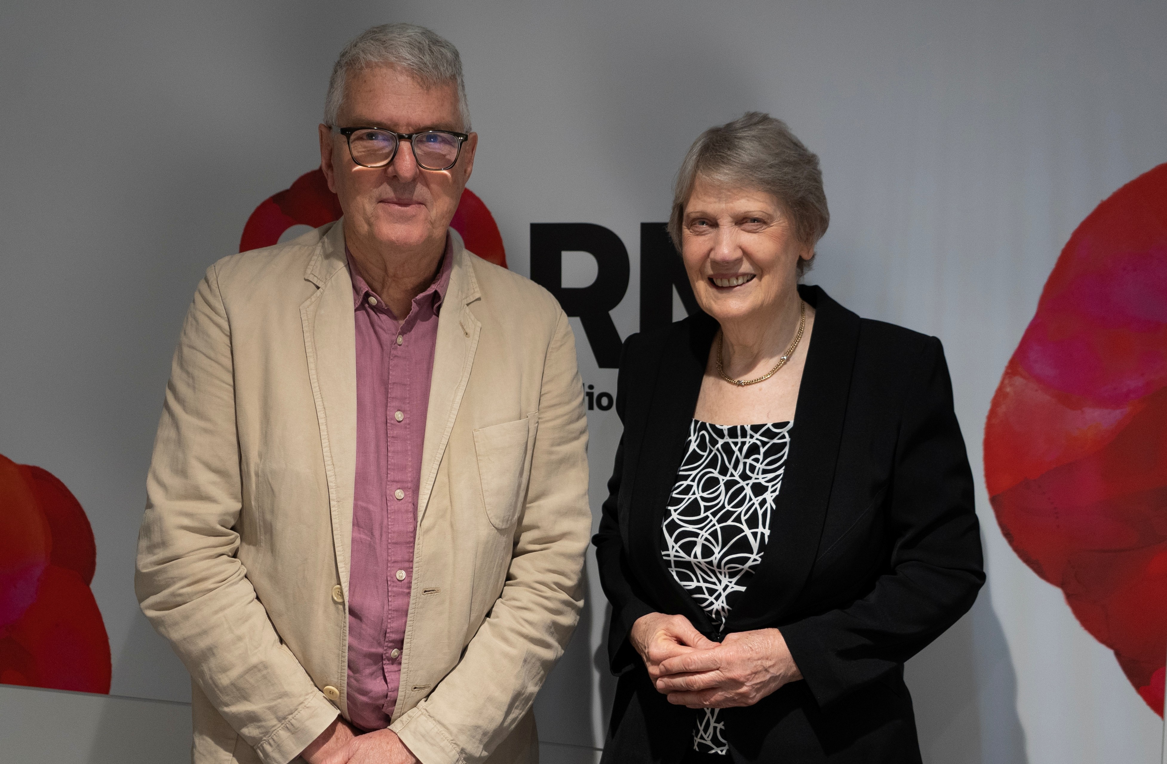 A man and a woman standing next to each other outside a radio studio
