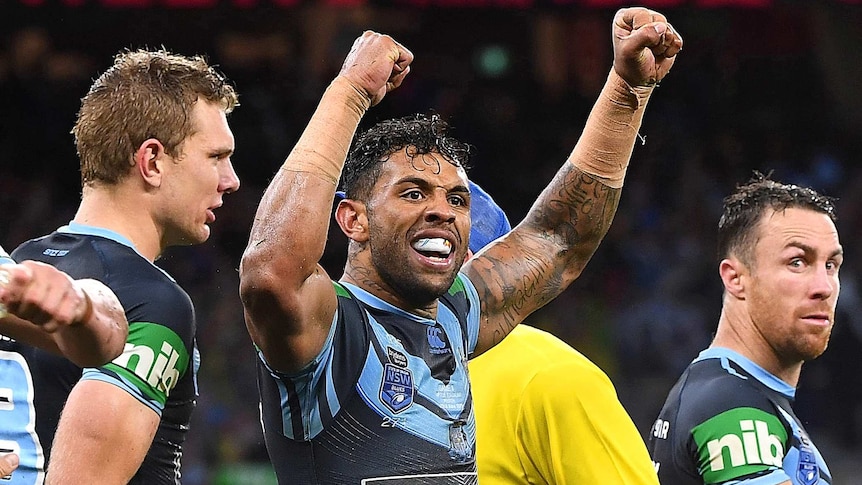 Josh Addo-Carr celebrates a try by clenching his biceps as James Maloney looks on
