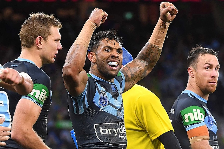 Josh Addo-Carr celebrates a try by clenching his biceps as James Maloney looks on