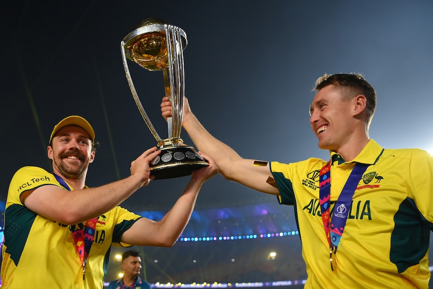 Travis Head and Marnus Labuschagne hold up the World Cup trophy