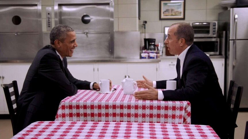 Barack Obama drinks coffee with Jerry Seinfeld in the White House staff dining room.