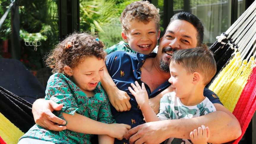 Ask Me Anything presenter Scott Kneebone at home with his three children.