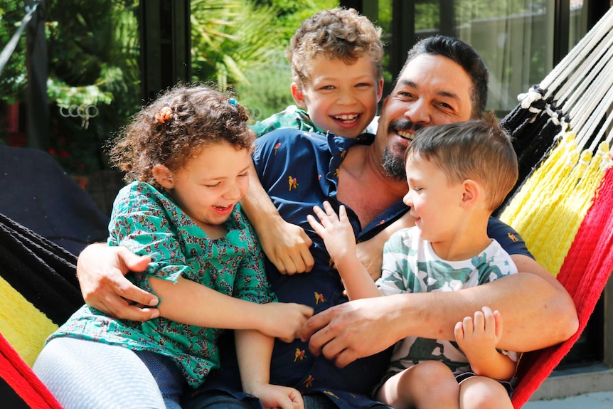 Ask Me Anything presenter Scott Kneebone at home with his three children.