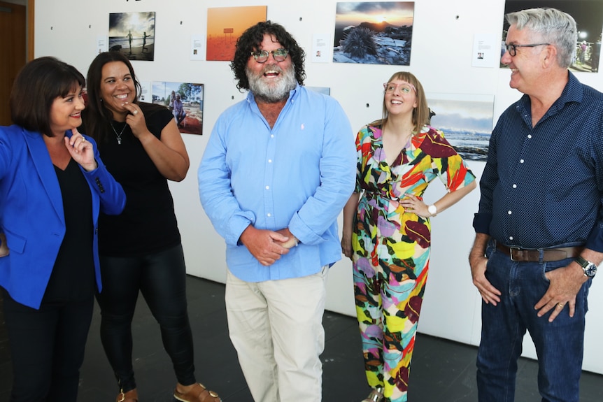 Five radio presenters pose for a group shot indoors