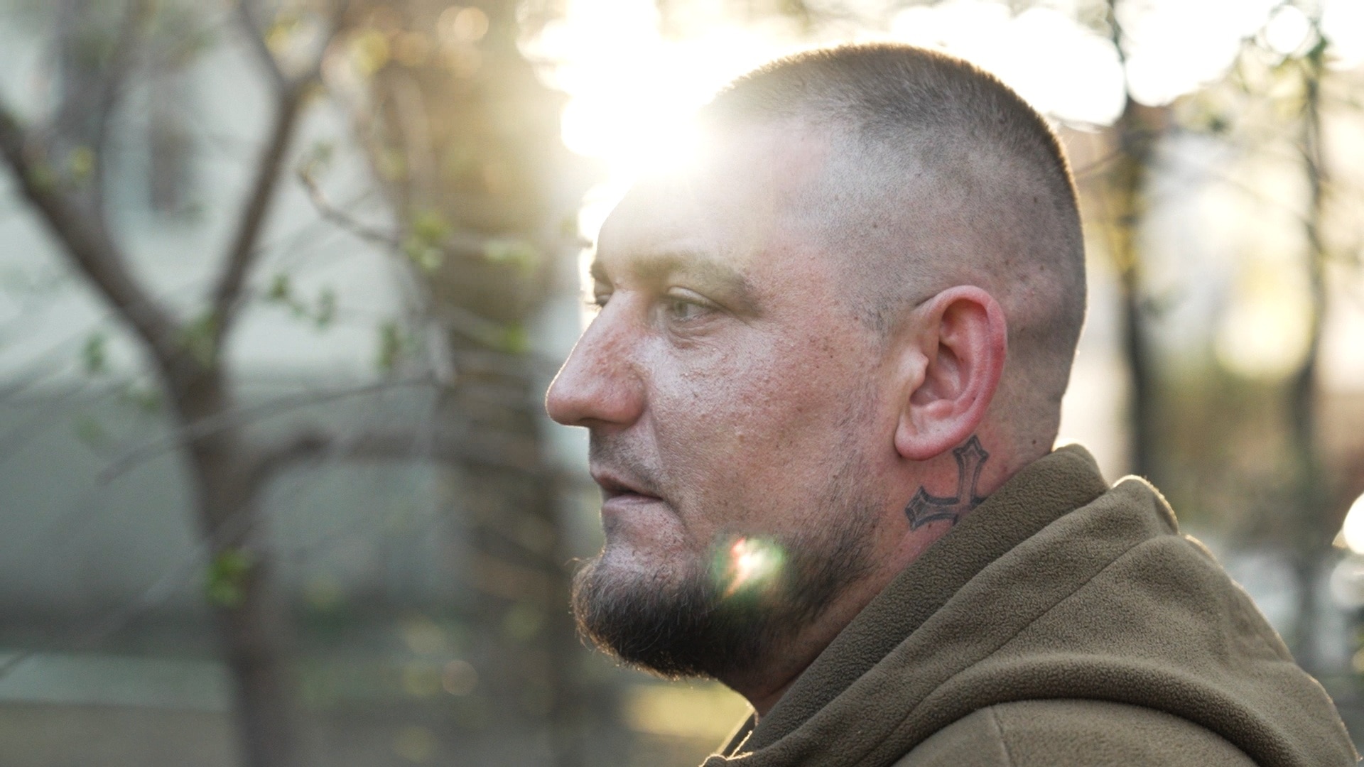 The side profile of Yaroslav wearing a green hoodie.