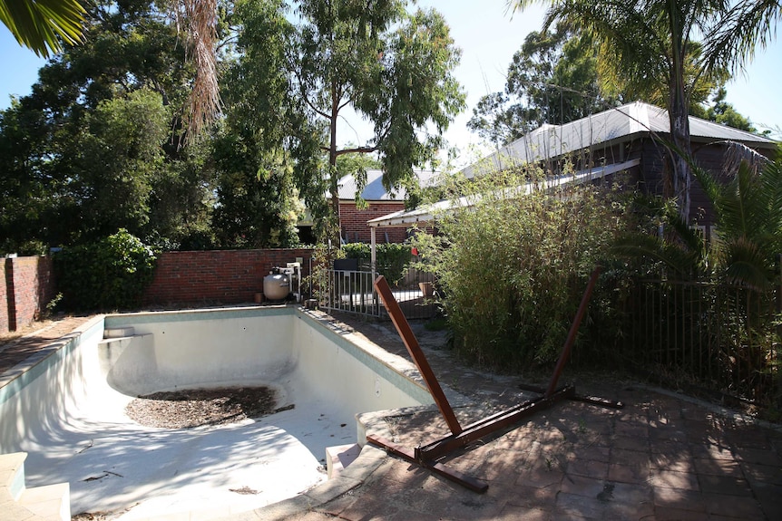 An empty swimming pool at the front of the Victoria Park House