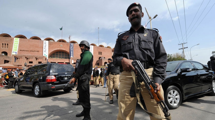 Pakistani policemen stand guard outside The National Stadium