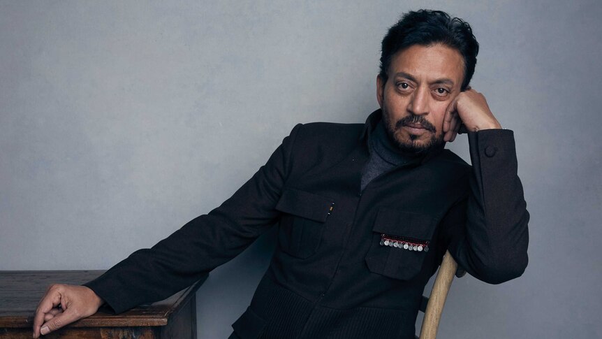 Irrfan Khan poses for a portrait in a grey jacket.