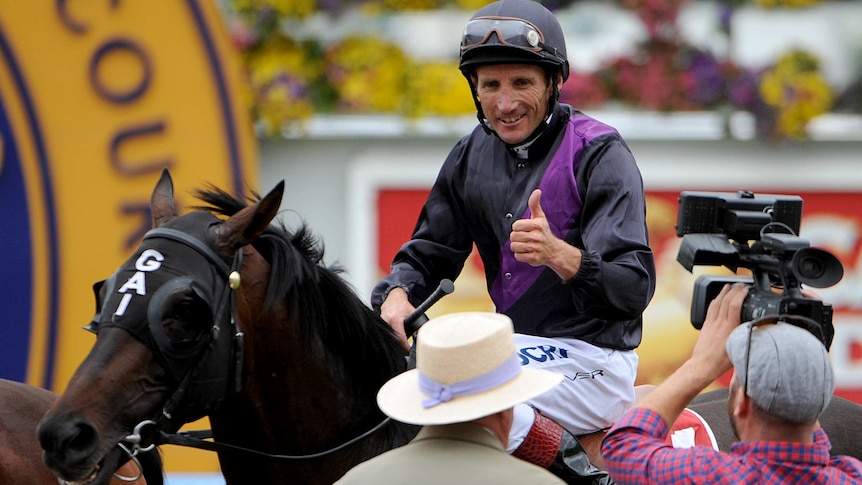 Winning return ... Damien Oliver celebrates on board Fiorente