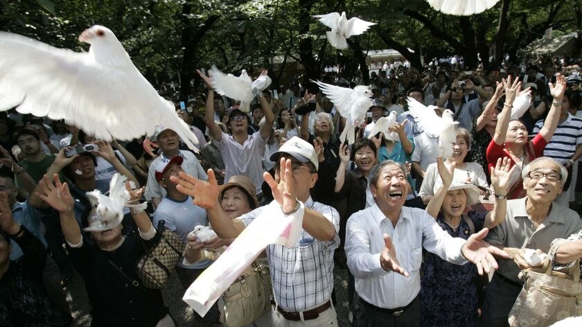 Visitors release doves at the Yasukuni Shrine in Tokyo on the 62nd anniversary of Japan surrendering in World War II.