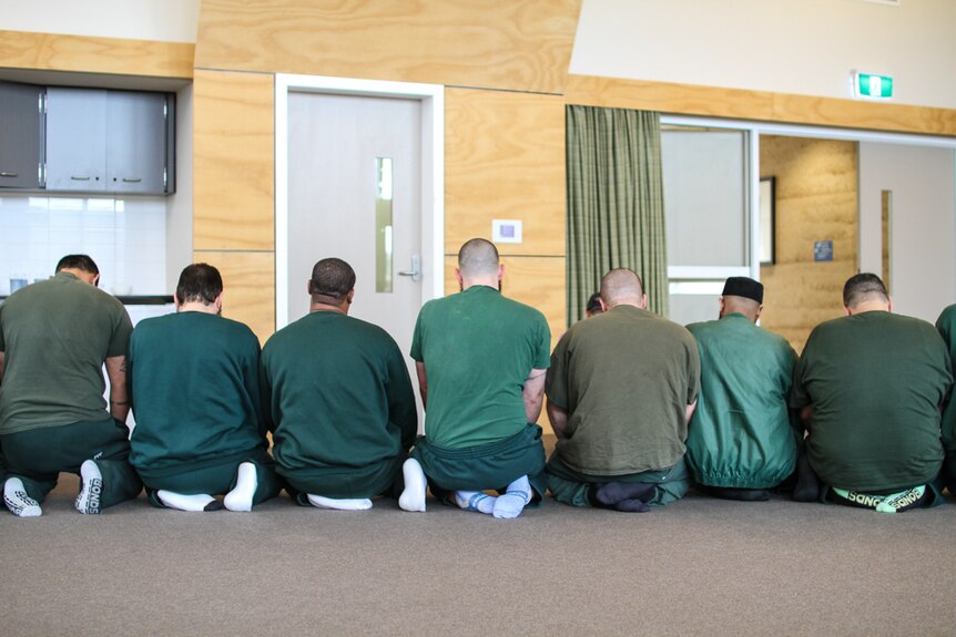 A row of inmates at the multi-faith chapel at Hopkins Correctional Centre in Ararat praying on their knees.