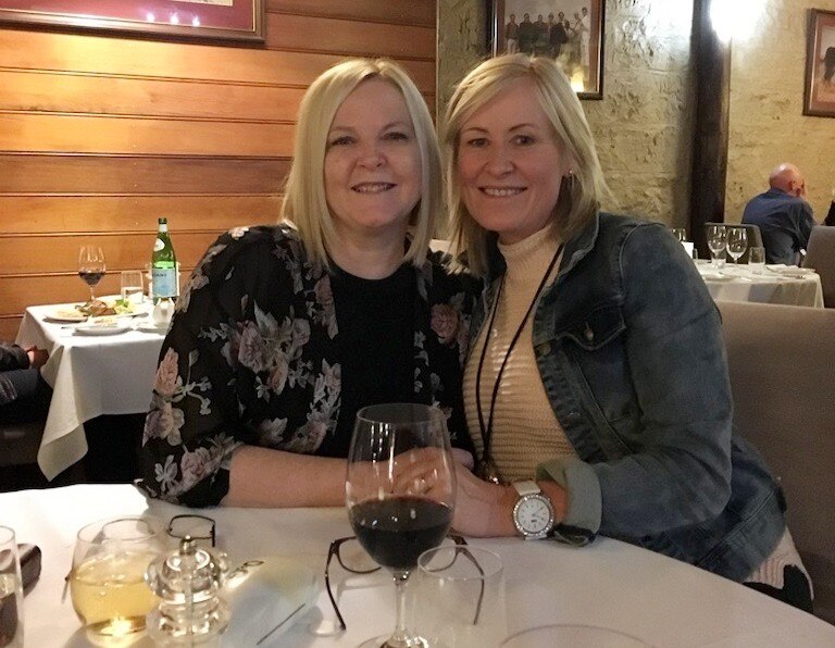 Two women sitting at a table in a restaurant