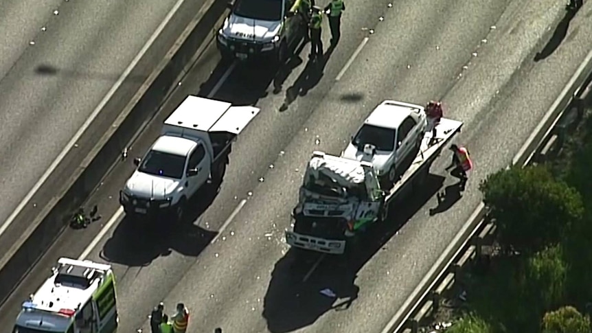 An overhead view of a damaged truck being removed from a road.