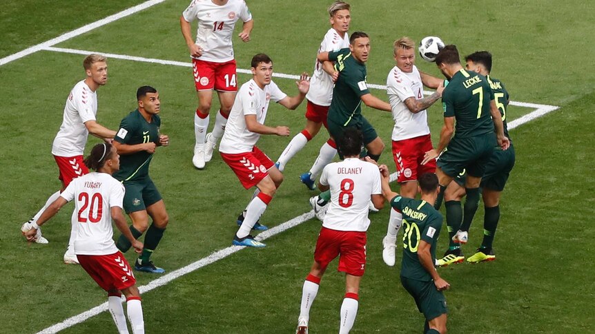 Mat Leckie wins a header