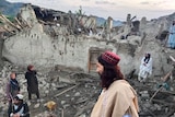 An image provided by Afghanistan state news agency showing residents surveying the damage from the earthquake. 