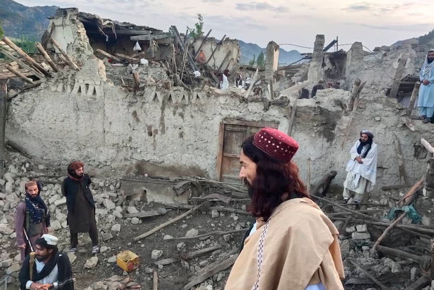 An image provided by Afghanistan's state news agency shows residents investigating the quake. 