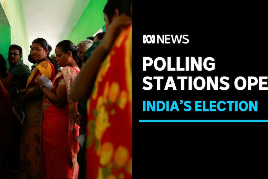 Polling Stations Open, India's Election: A group of people line up at a polling station.