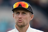An England male cricketer makes a gesture with his hands during a Test against India.
