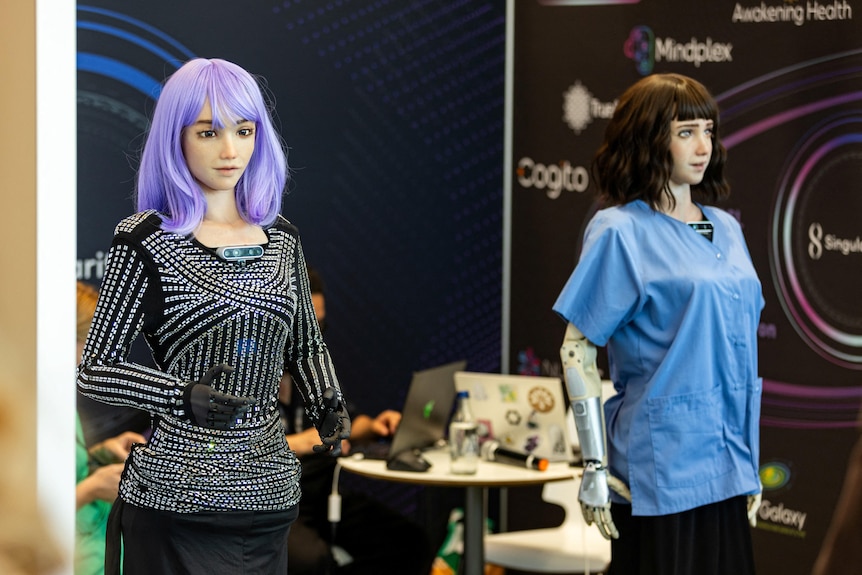 Two humanoid robots standing next to each other. 