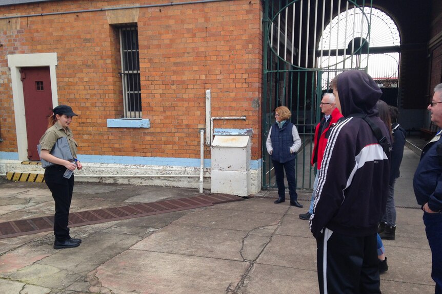 A tour group learns the history of Boggo Road Gaol.