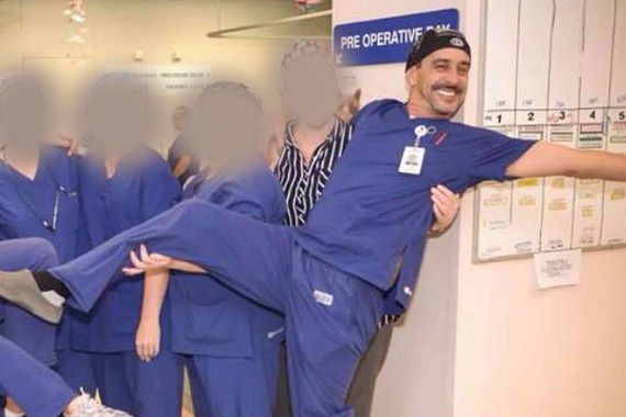 A group of nurses standing in a row wearing surgical scrubs