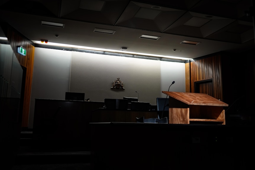 An empty courtroom with lights behind where the judges sit.