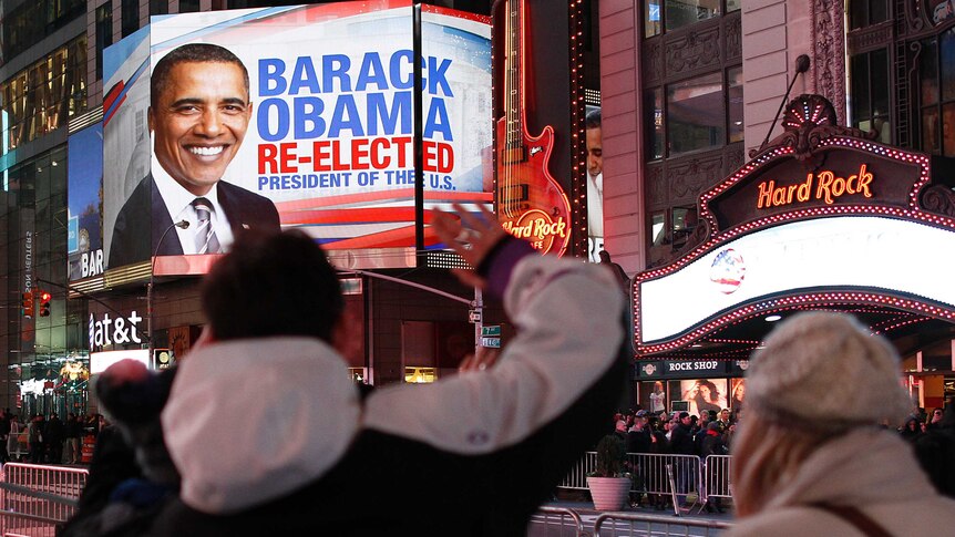 People celebrate in Times Square, New York, after Barack Obama wins the 2012 US presidential election.
