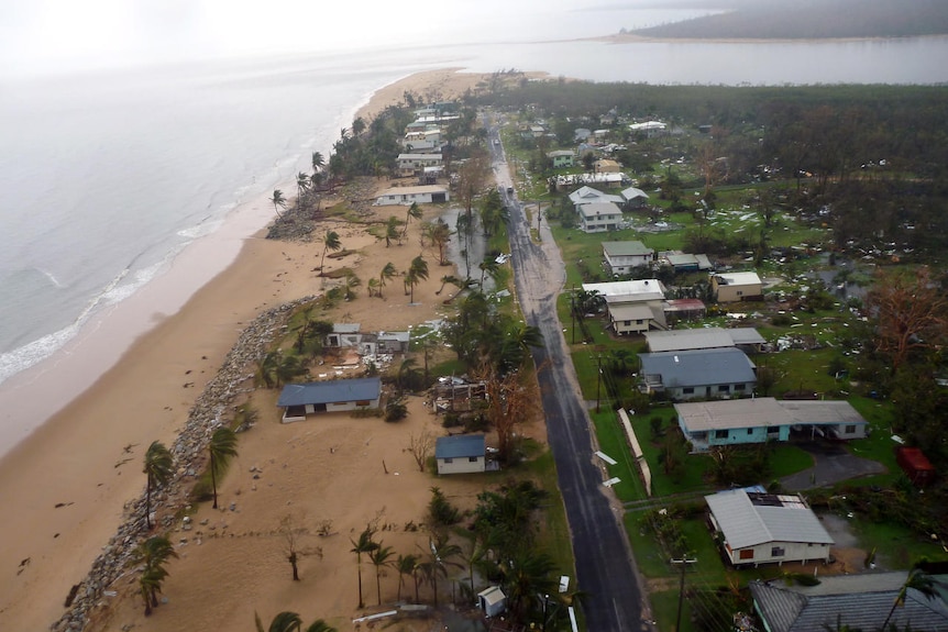 An aerial shot showing a stretch of coastline that has been ravaged by a powerful storm.