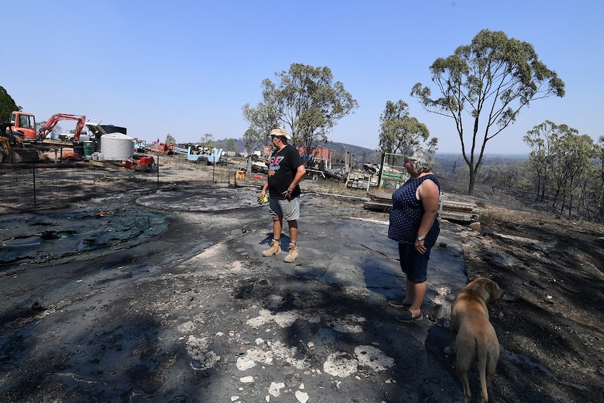 Nick and Jeanette Schwindt inspect their burnt-out water tanks.