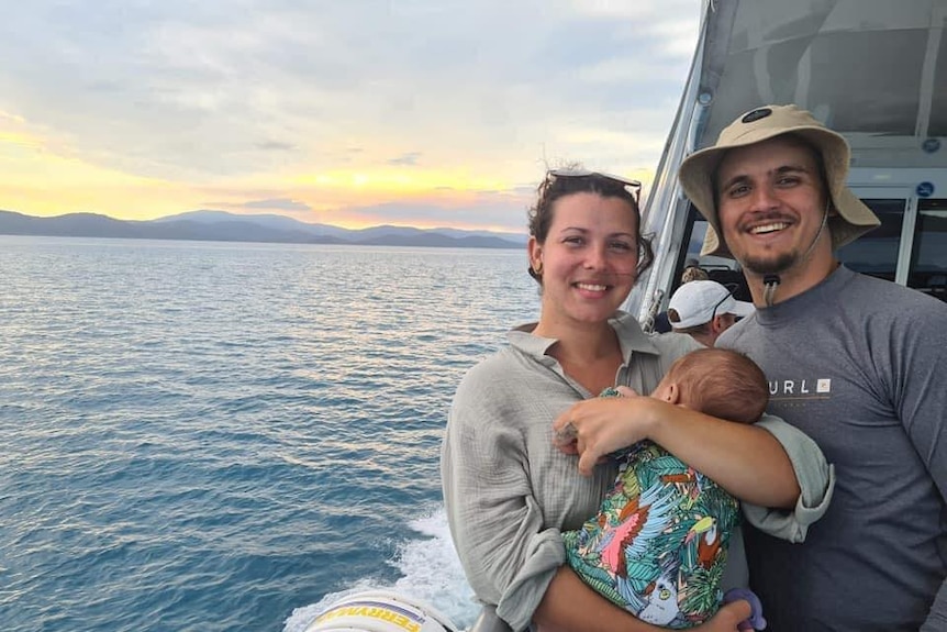 A couple and a child on a boat.