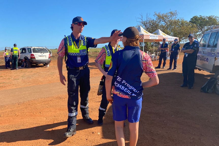 A volunteer orders a young boy away from the crash site