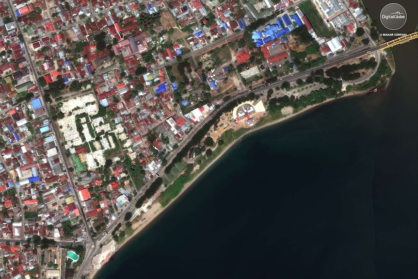 This August 17, 2018, satellite photo provided by DigitalGlobe shows a view of the waterfront near the bridge in Palu, Indonesia.