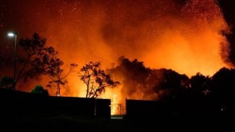 Glowing bushfire and blowing embers out the back of a Peregian Beach property
