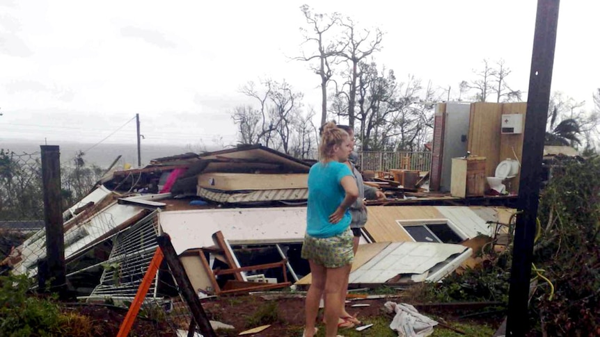 Mission Beach residents survey the remains of their after Cyclone Yasi battered the North Queensland town in 2011.