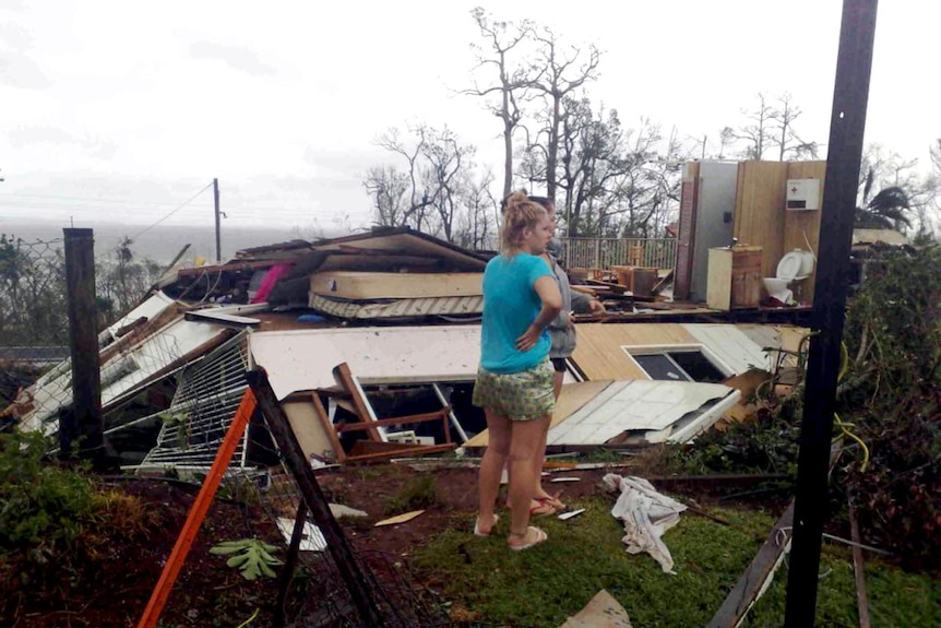 Mission Beach residents survey the remains of their home after Cyclone Yasi.