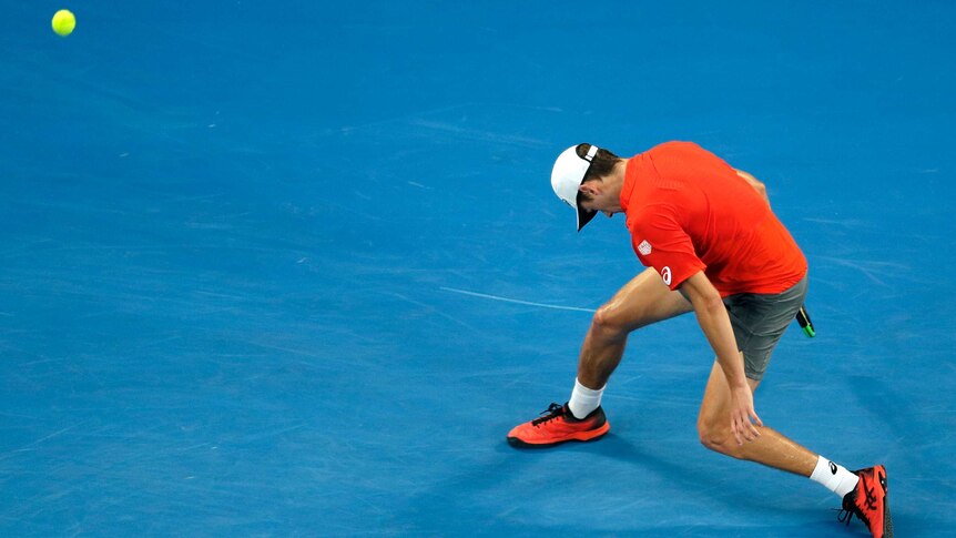 Tennis player slumps after losing a point at the Australian Open.