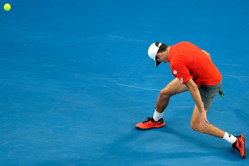 Tennis player slumps after losing a point at the Australian Open.