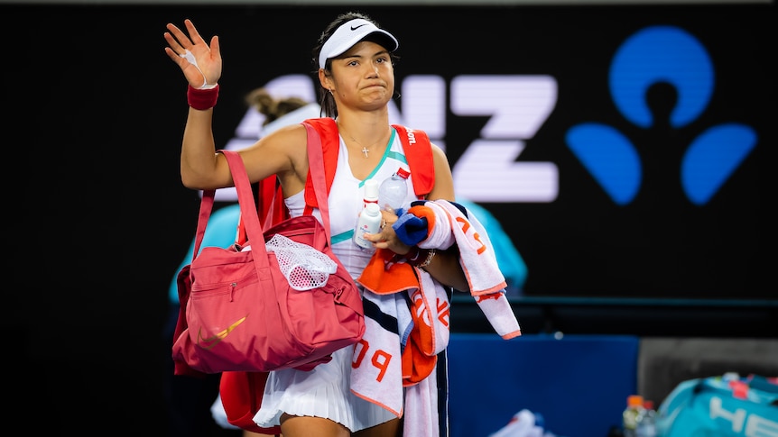 A British female tennis player waves to the crowd at the Australian Open.