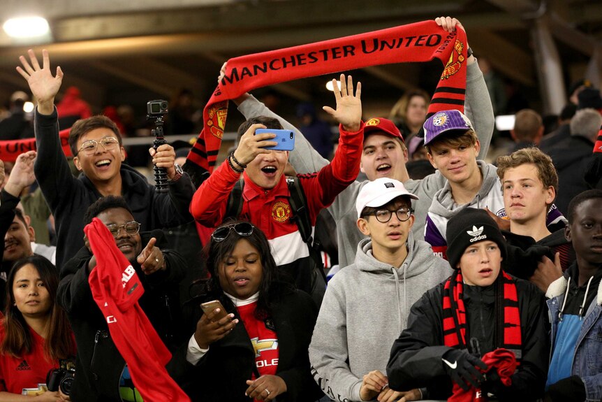 Manchester United fans hold up