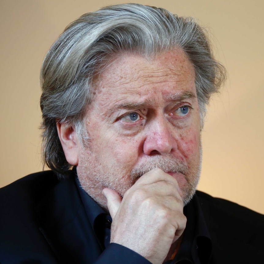 Close up of Steven Bannon's head as he looks to the right, while wearing a black turtleneck