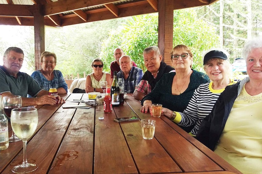Australian tourists, stranded on Norfolk Island, sit at a picnic table shelter at a barbecue at Captain Cook Lookout.