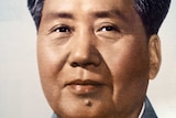 Headshot of Mao Zedong in grey overcoat.