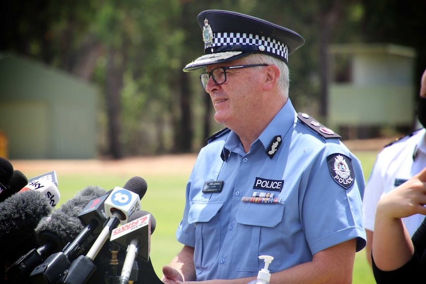WA Police commissioner Chris Dawson in front of microphones