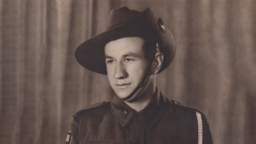 Studio portrait of a young man in a World War Two Australian Army uniform and slouch hat.