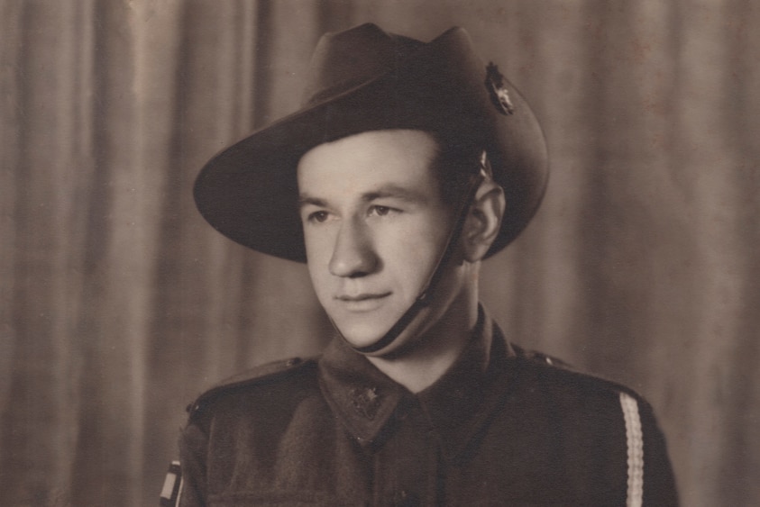 Studio portrait of a young man in a World War Two Australian Army uniform and slouch hat.