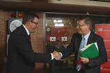 Denis Napthine and Daniel Andrews shake hands