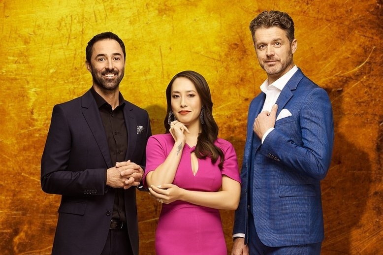 Jock Zonfrillo, Melissa Leong and Andy Allen are standing together in front of a gold screen. All are immaculately dressed.