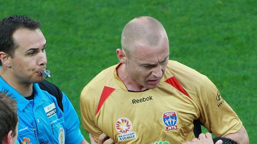 Newcastle's Jobe Wheelhouse clashes with Aziz Behich of the Melbourne Heart during 2010's round 17 match.