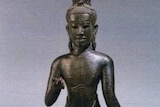 A stone Cambodian sculpture of a figure.