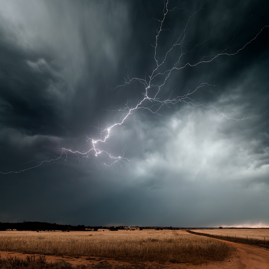 Lightning strikes through clouds